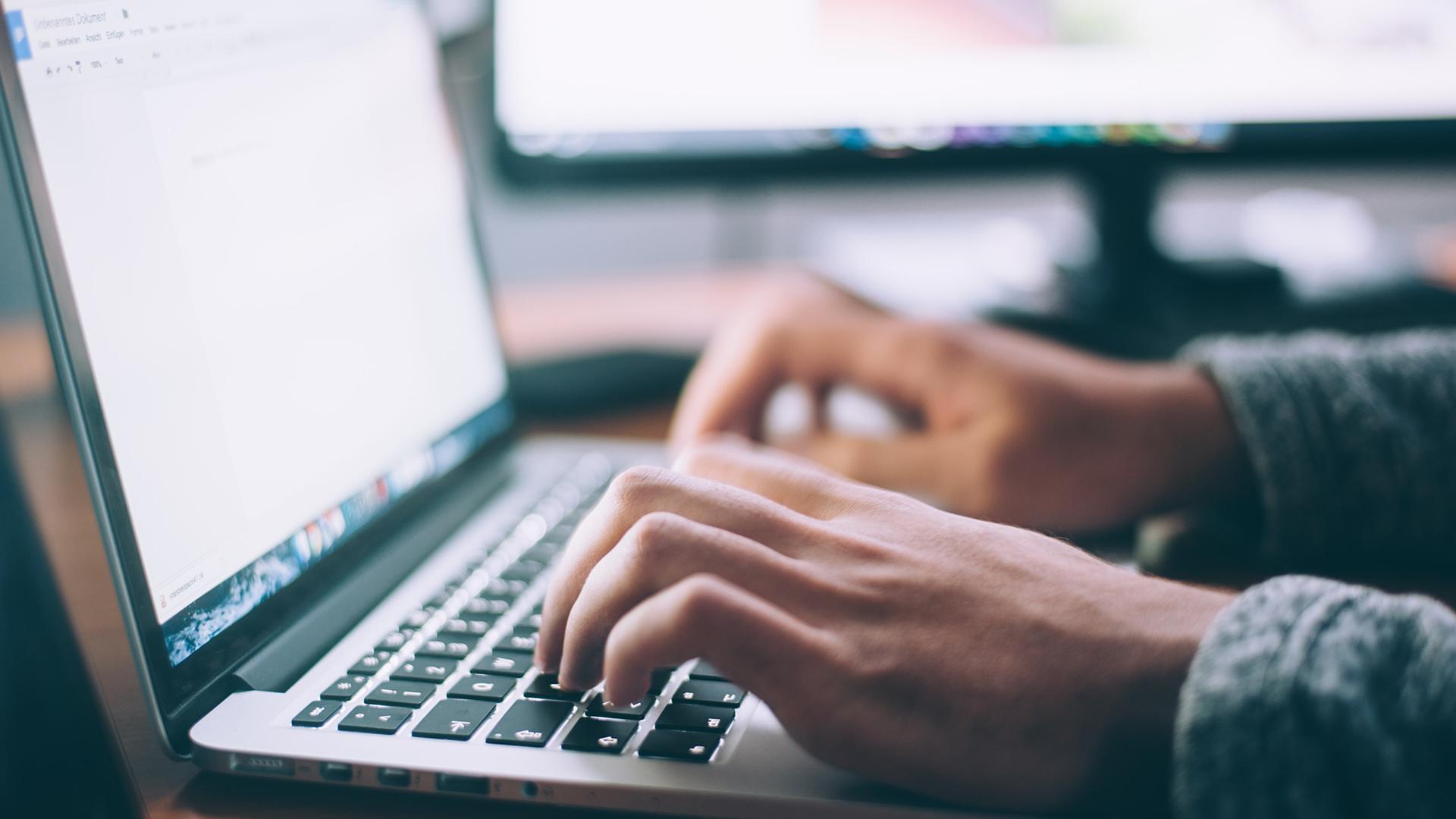 Close up of person using a laptop