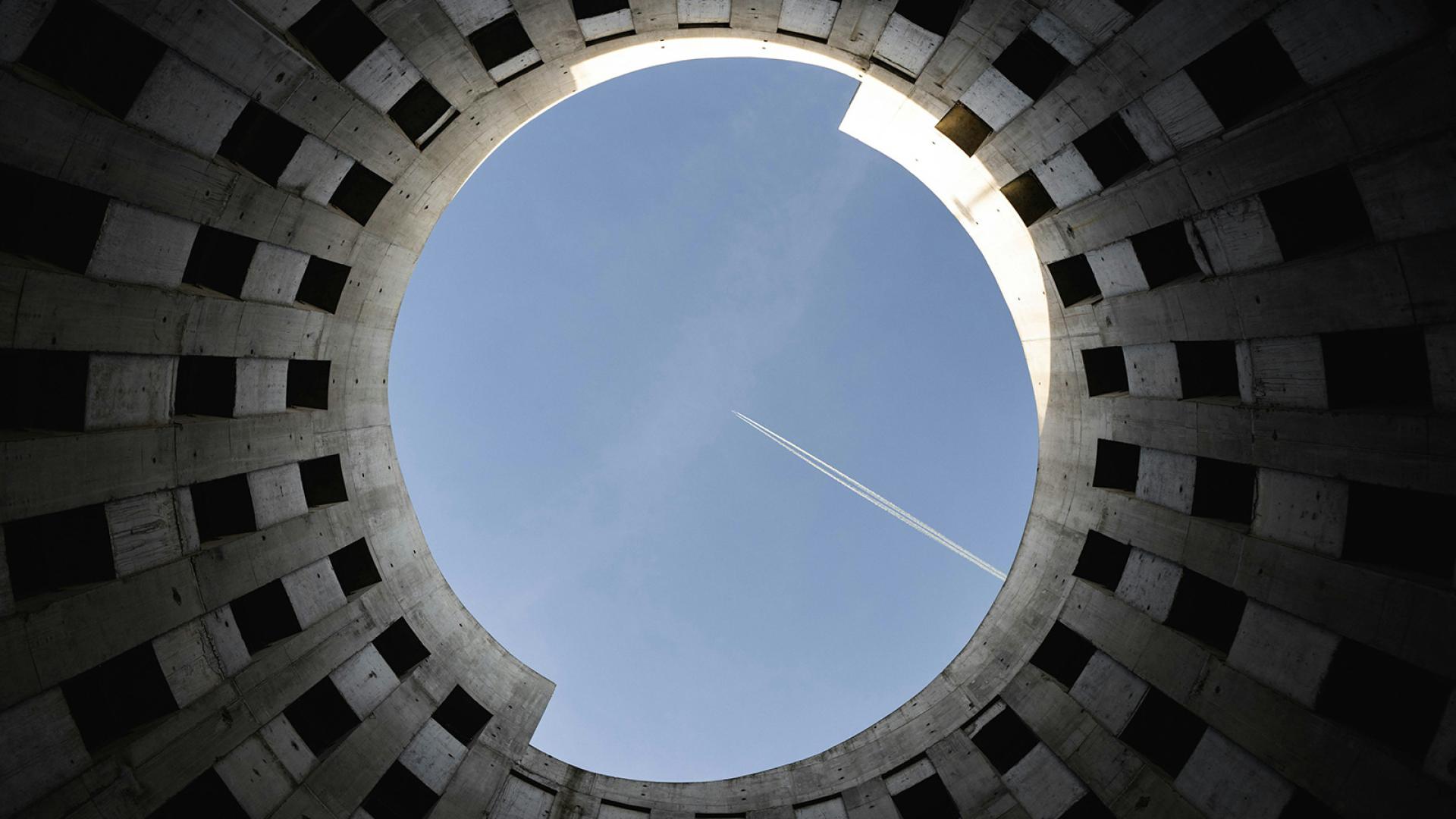 Plane flying over circular building